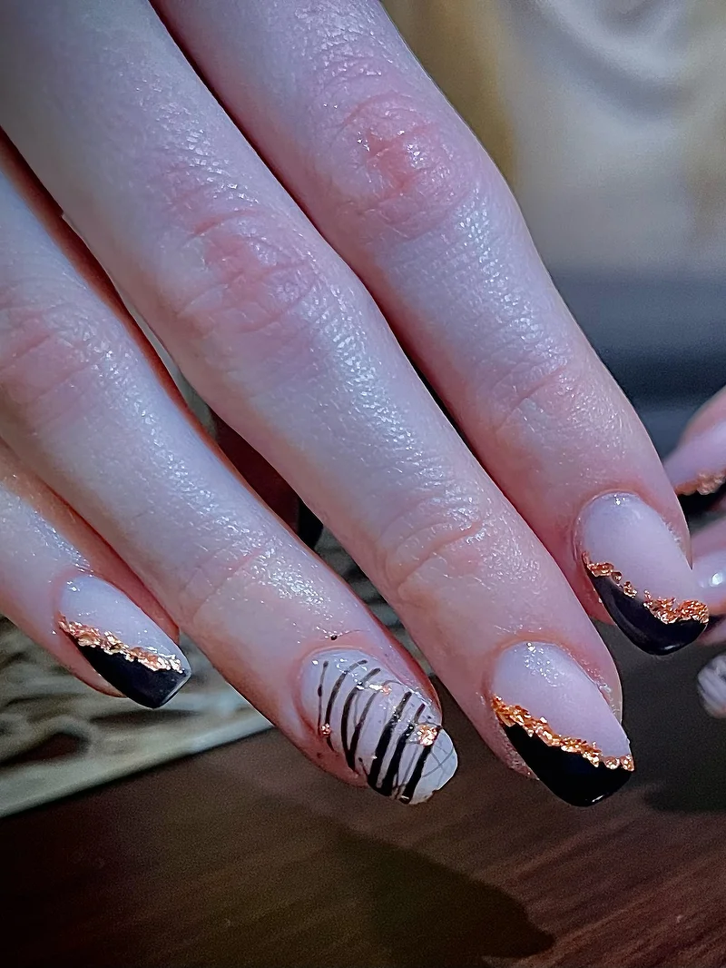 Black nails with copper foil and zebra pattern
