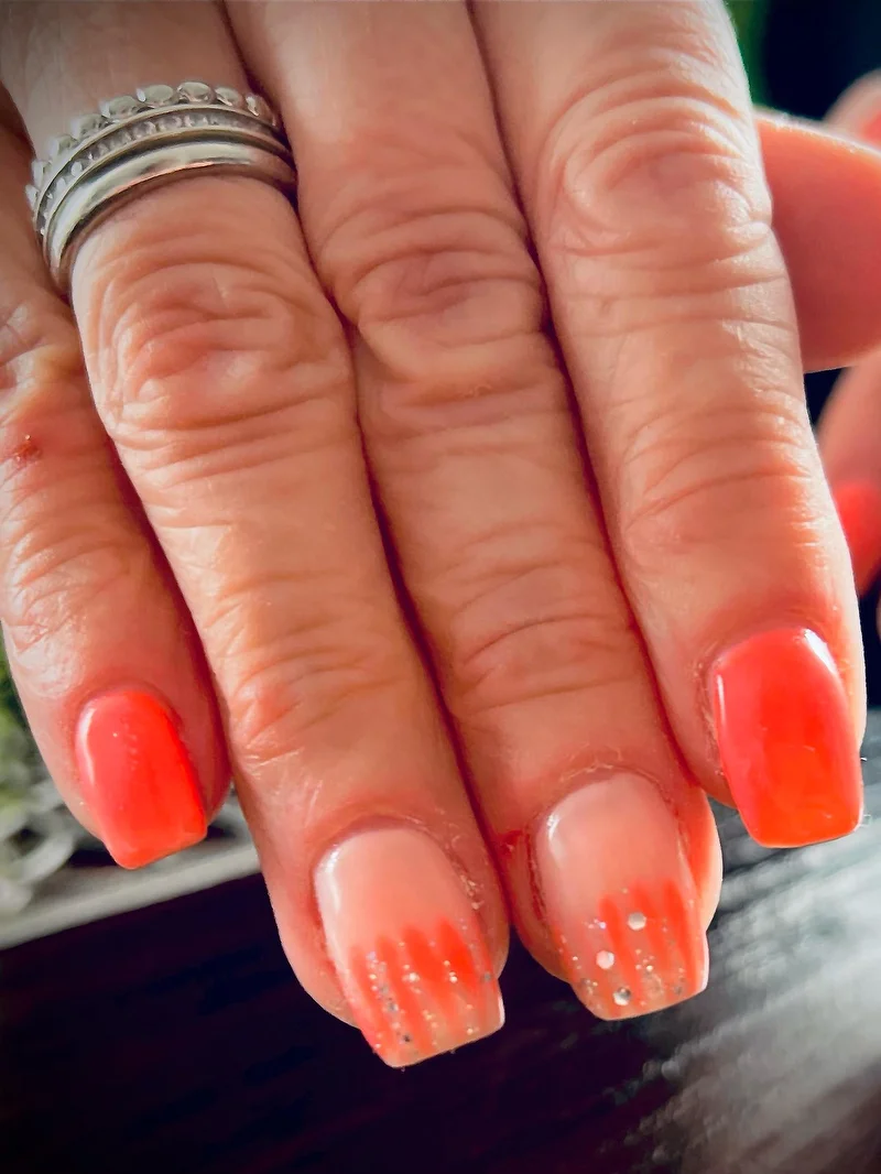 Coral and orange nails with glitter dots