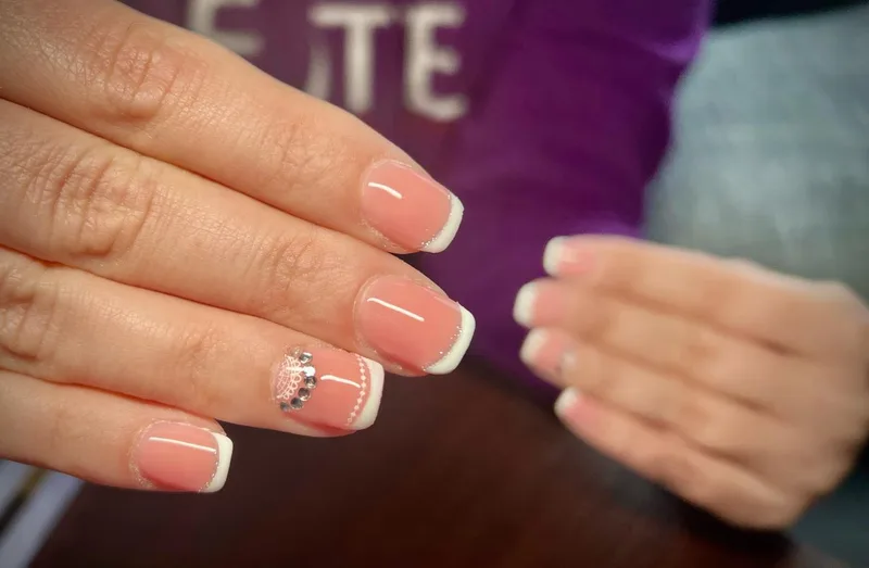 French tip nails with lace detail and gems
