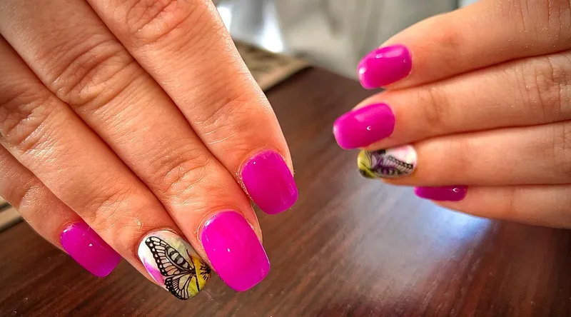 Hot pink nails with butterfly nail art