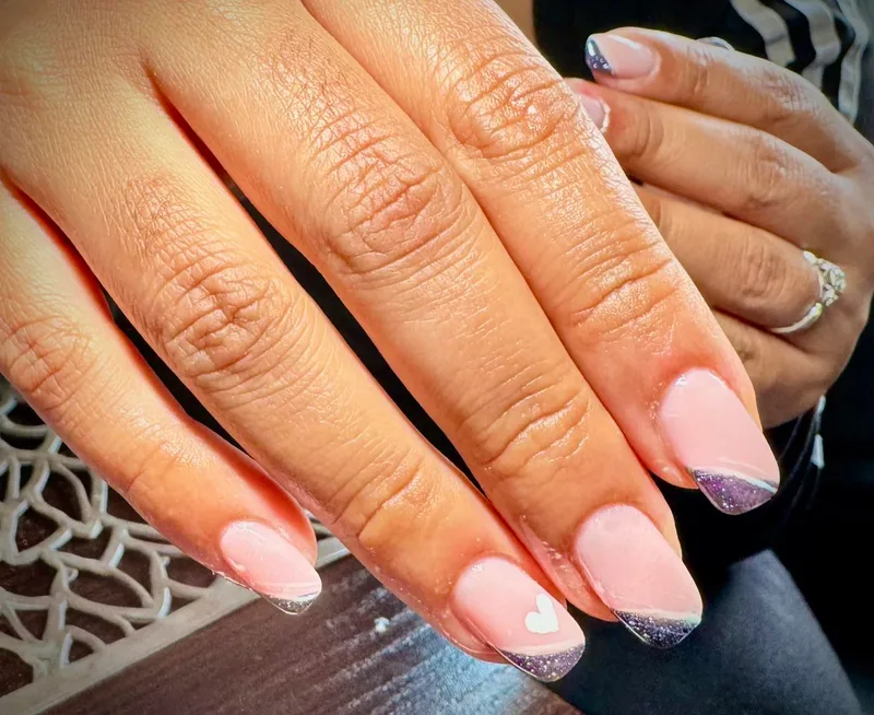 Nude nails with purple glitter tips and heart