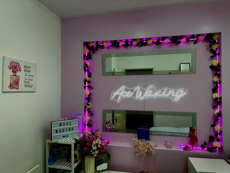 Ace Waxing branded neon wall with Treatwell award